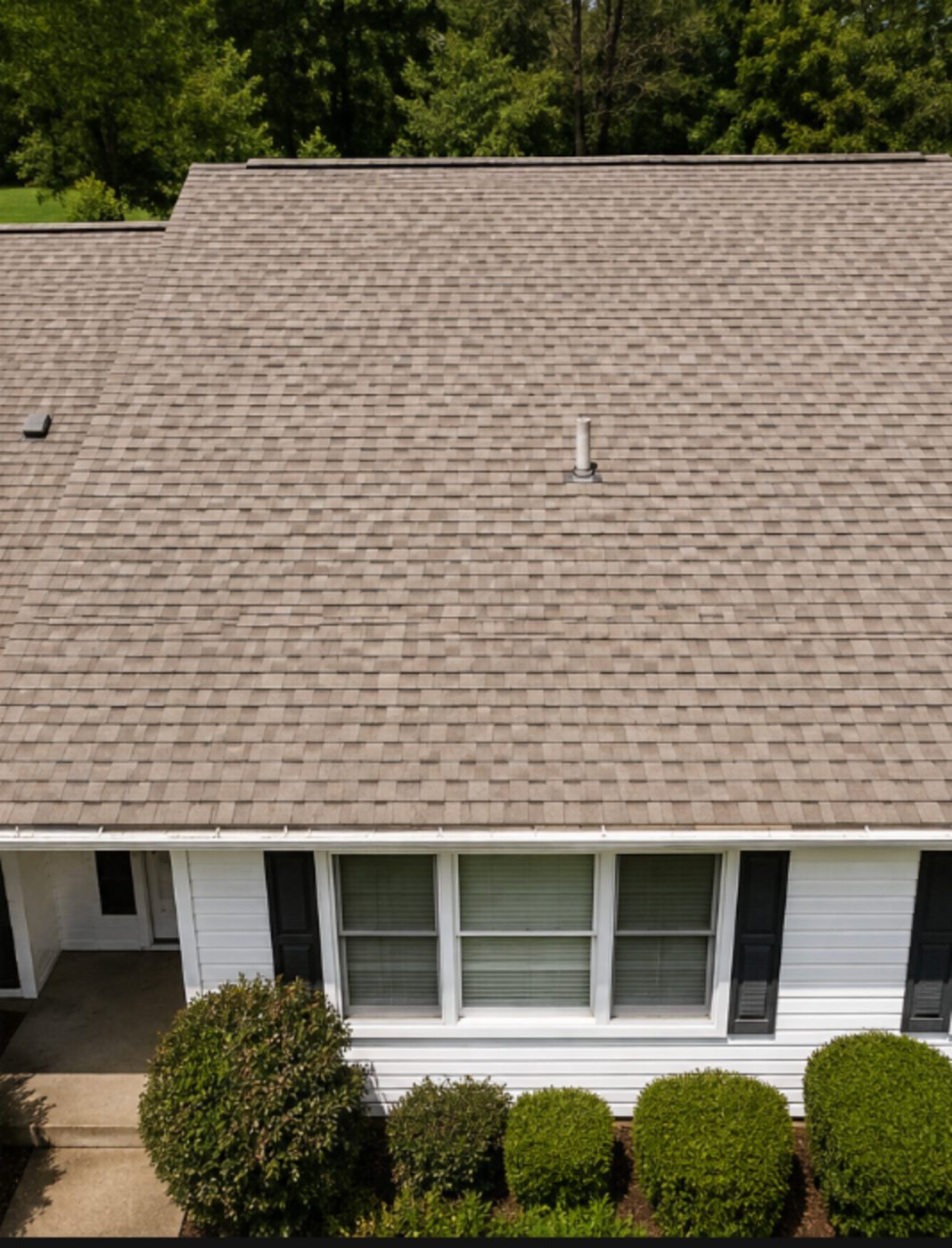 The same shingle roof with even color restored after soft washing